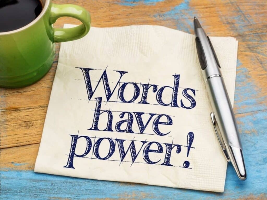 The House Sitter’s Hub: Everything You Need for a Five-Star Sit 16 A napkin with Words have power! in bold blue letters rests on a wooden table. A silver pen lies on it, hinting at thoughts of house sitting adventures penned down during quiet mornings, while a green cup filled with coffee sits nearby, embracing the tranquility of planning for house sitting 101.